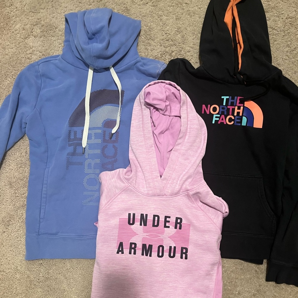 North Face and UA sweatshirts